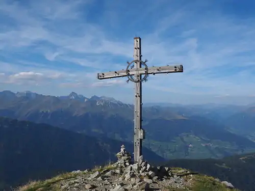 large cross atop Jaufenspitze mountain summit in South Tyrol, Italy in the Stubai Alps at an elevation of 2,331 m.